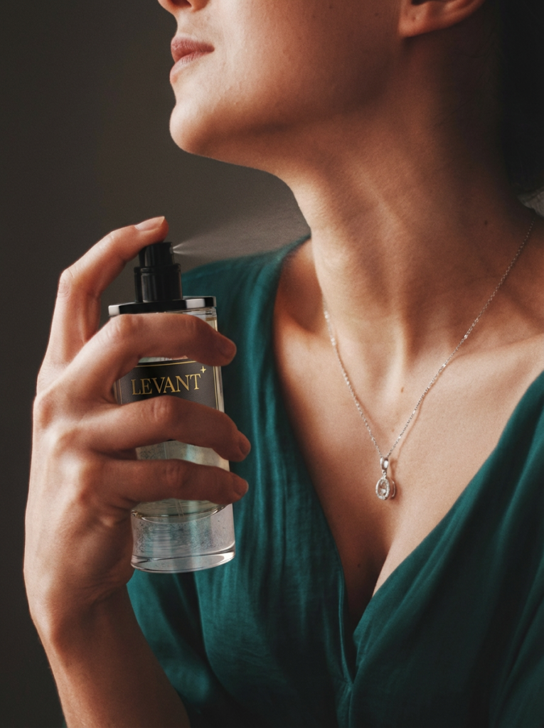 woman spraying perfume